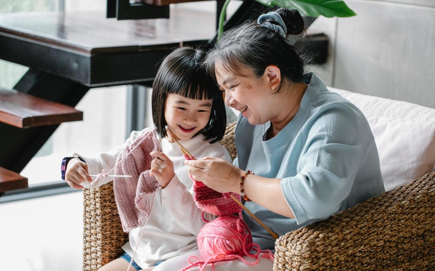 Grandmother and granddaughter knitting together